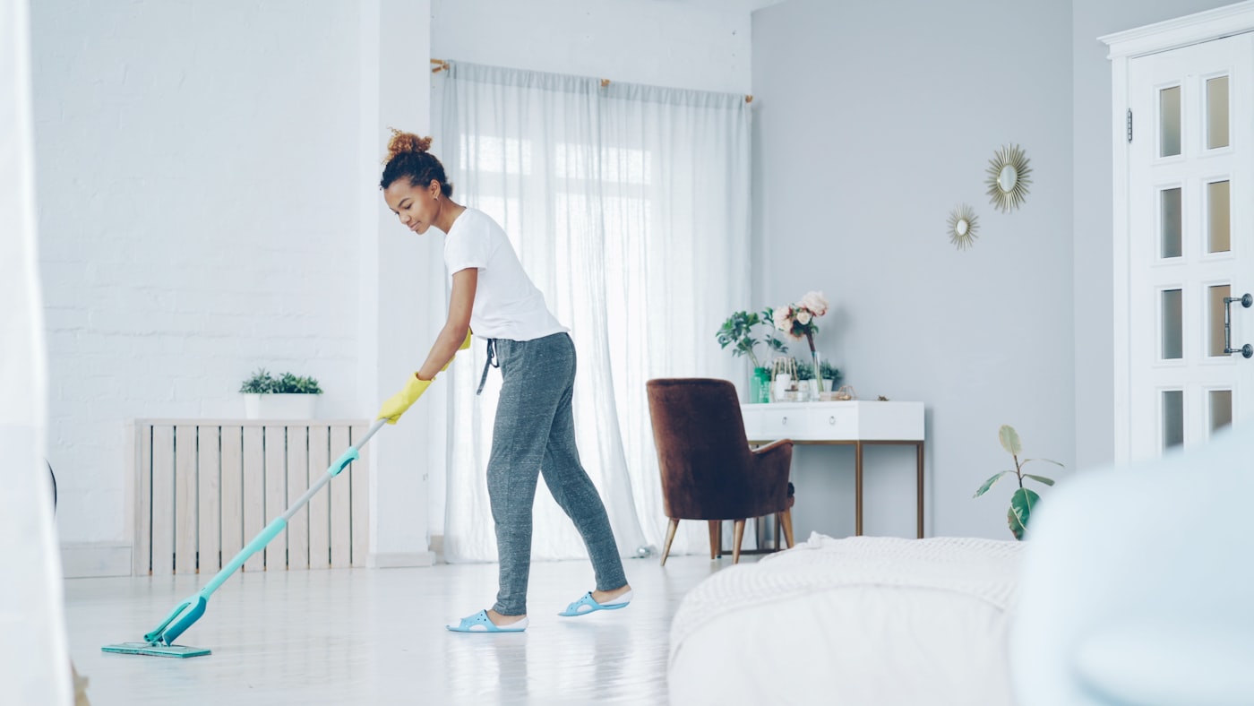 Professional cleaner tidying a bright home